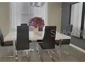 Modern dining room with table, chairs, and stylish decor at 4751 Clock Tower Dr # 103, Kissimmee, FL 34746