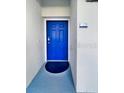 Bright blue front door enhances the curb appeal of this home at 4751 Clock Tower Dr # 103, Kissimmee, FL 34746