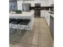 Spacious kitchen with an island, sleek appliances, and ample counter space at 4751 Clock Tower Dr # 103, Kissimmee, FL 34746