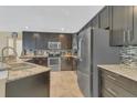 Modern kitchen featuring granite countertops, stainless steel appliances, and dark wood cabinets at 5056 Gandross Ln, Mount Dora, FL 32757