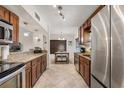 Spacious kitchen featuring stainless steel appliances, granite countertops, and dark wood cabinetry at 5606 Eggleston Ave, Orlando, FL 32810