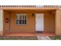 Exterior view of entryway featuring white front door with large window and red fire extinguisher on wall at 707 Michigan Ct # 2, St Cloud, FL 34769