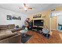 Cozy living room featuring a comfortable brown sofa, stylish decor, and wood laminate flooring at 707 Michigan Ct # 2, St Cloud, FL 34769