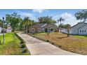 Attractive home with a long driveway, lush landscaping, and mature trees on a spacious lot at 841 Oaks Shores Rd, Leesburg, FL 34748