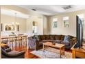 Spacious living room featuring hardwood floors, recessed lighting, and a comfortable brown sofa at 9020 Breezy Meadow Way, Orlando, FL 32829