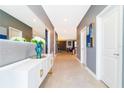 Hallway featuring stylish console table with decor, tiled floors and neutral wall color at 9332 Sommerset Hills Dr, Davenport, FL 33896