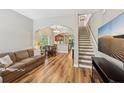 Open-concept living room with hardwood floors and staircase to upper level at 10404 Park Commons Dr, Orlando, FL 32832