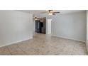 Bright living room featuring neutral walls, tile flooring, and a ceiling fan at 1051 Arden St, Longwood, FL 32750