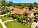 Aerial view of a well maintained home with lush tropical landscaping and a beautiful lawn at 1121 Arbor Glen Cir, Winter Springs, FL 32708