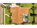 Aerial view of roof, screened pool, lush green lawn and landscaping at 1121 Arbor Glen Cir, Winter Springs, FL 32708