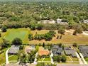 Expansive aerial view of a residential area with lake views and green spaces and several homes at 1121 Arbor Glen Cir, Winter Springs, FL 32708