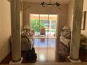 Elegant living room featuring hardwood floors and sliding glass doors to the pool area at 1121 Arbor Glen Cir, Winter Springs, FL 32708