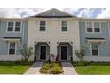 Attractive townhouse with light blue siding, white accents, and a welcoming front entrance at 1286 Shoreside St, Clermont, FL 34714