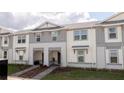 Charming two-story townhomes feature craftsman-style details and a landscaped front yard at 1286 Shoreside St, Clermont, FL 34714