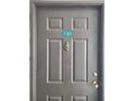 Close-up of the gray front door with a door knocker and unit number 513 at 14001 Fairway Island Dr # 513, Orlando, FL 32837
