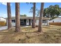 Cozy home featuring a well-manicured front lawn framed by mature trees and natural landscaping at 14120 Rutgers Ave, Orlando, FL 32826