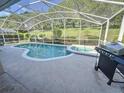 Relaxing screened-in pool with a connected jacuzzi and a well-maintained patio at 143 Windsor Pl, Davenport, FL 33896