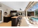 Resort-style backyard featuring outdoor bar, covered patio, and sparkling pool for ultimate relaxation and entertainment at 1525 Eagle Nest Cir, Winter Springs, FL 32708