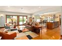 Open-concept living room with hardwood floors, stylish furniture, and seamless flow to the outdoor pool area at 1618 Pepperidge Dr, Orlando, FL 32806