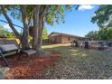 Spacious backyard with mature trees, outdoor furniture, and a peaceful, natural setting at 1620 Carolyn Ct, St Cloud, FL 34769