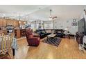 Bright living room featuring hardwood floors, a ceiling fan, comfortable seating and natural light at 20446 Macon Pkwy, Orlando, FL 32833