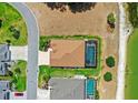 Aerial view of the property showcasing the backyard pool and proximity to the adjacent lake at 2086 Biller Cir, The Villages, FL 32163