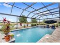 Enclosed pool area features a water feature, nearby lake view, and a comfortable lounge seating area at 2086 Biller Cir, The Villages, FL 32163
