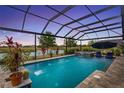 Screened-in pool with a water feature, with picturesque views of the adjacent golf course and pond at 2086 Biller Cir, The Villages, FL 32163