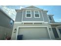 Two-story home showcasing a neutral color palette and an attached two-car garage at 264 Hayley St, Winter Haven, FL 33884