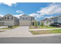 Two-story home with neutral tones, two-car garage, and well-maintained front yard at 264 Hayley St, Winter Haven, FL 33884