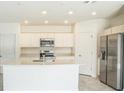 Bright kitchen featuring stainless steel appliances, an island with sink, and white cabinetry at 264 Hayley St, Winter Haven, FL 33884