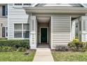 Inviting front door entrance with green door, complemented by lush green landscaping at 304 Southern Pecan Cir # 105, Winter Garden, FL 34787