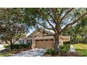 Lovely home with well-manicured front yard, mature trees, and a two car garage at 30546 Lipizzan Ter, Mount Dora, FL 32757