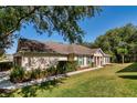 Beautiful home with well-maintained lawn, manicured landscaping, and sidewalk leading to the entrance at 30546 Lipizzan Ter, Mount Dora, FL 32757