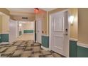 Hallway with decorative flooring, neutral paint with accent trim, and multiple doors at 322 E Central Blvd # 1909, Orlando, FL 32801
