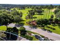 Aerial view of the Kings Ridge entrance and golf course at 3586 Eversholt St, Clermont, FL 34711