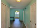 Bright hallway with wood-look flooring and a view to the living spaces at 3586 Eversholt St, Clermont, FL 34711