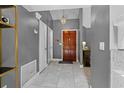 Inviting home entryway featuring tile floors, chandelier, and wooden door at 408 S Winsome Ct, Lake Mary, FL 32746