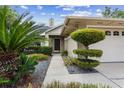 Landscaped front yard with a concrete walkway leading to the front door and garage at 408 S Winsome Ct, Lake Mary, FL 32746