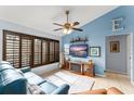 Bright living room with a fireplace, window shutters, and tile flooring at 43825 State Road 19, Altoona, FL 32702