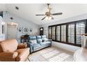 Cozy living room features tiled floors, window shutters, and comfortable seating at 43825 State Road 19, Altoona, FL 32702