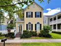 Charming two-story home featuring a welcoming front porch, lush landscaping, and classic architectural details at 508 Sycamore St, Celebration, FL 34747