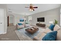 Comfortable living room features neutral paint, plush carpet and furniture, and a ceiling fan at 530 Hiawatha Palm Pl, Apopka, FL 32712