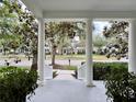 View from the front porch showing the neighborhood street lined with trees and other lovely homes at 616 Nadina Pl, Celebration, FL 34747