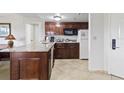 Functional kitchenette featuring granite countertops, wooden cabinets, and modern appliances at 6402 Parc Corniche Dr # 5304, Orlando, FL 32821