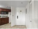 Efficient kitchenette with a microwave, granite countertops, cabinets, and tile floors at 6402 Parc Corniche Dr # 5304, Orlando, FL 32821