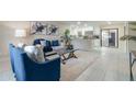Open-concept living area with stylish furnishings, modern decor, and seamless flow into the adjacent kitchen space at 741 Orange Ave, Longwood, FL 32750