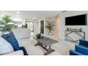 Cozy living room featuring neutral tones, an open layout, and lots of natural light with views into the backyard at 741 Orange Ave, Longwood, FL 32750