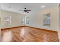 Spacious bedroom with hardwood floors, ceiling fan, and many windows for natural light at 902 Hire Cir, Ocoee, FL 34761