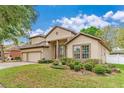 Charming two-story home with a three-car garage and well-manicured landscaping at 902 Hire Cir, Ocoee, FL 34761